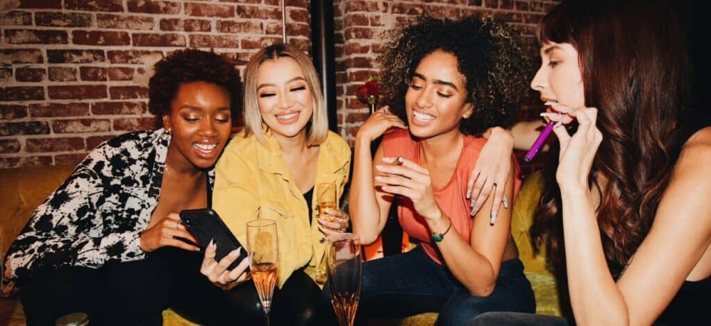 Women enjoying champagne and smiling