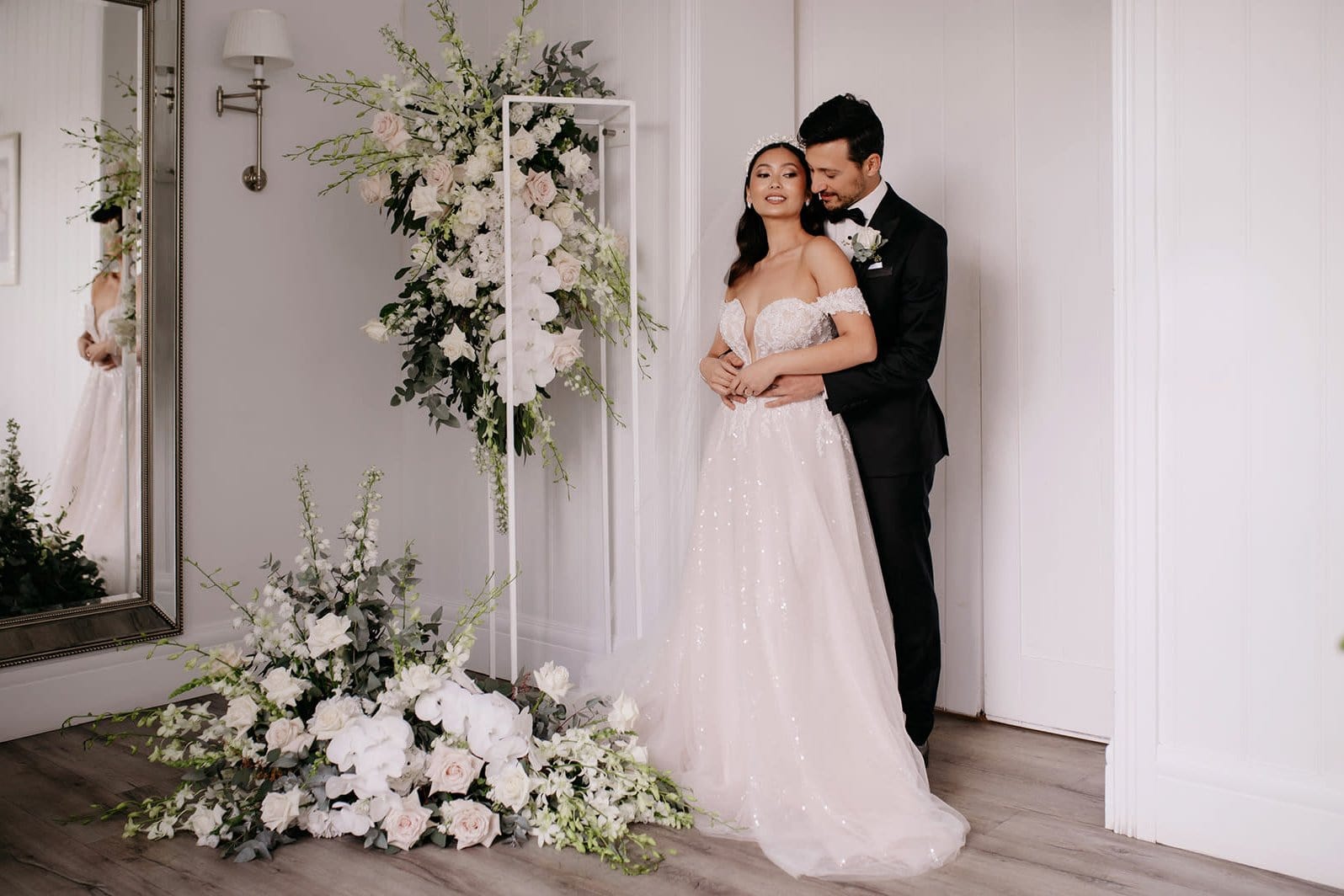 Bride and groom posing near floral arrangement at formal Columbus wedding