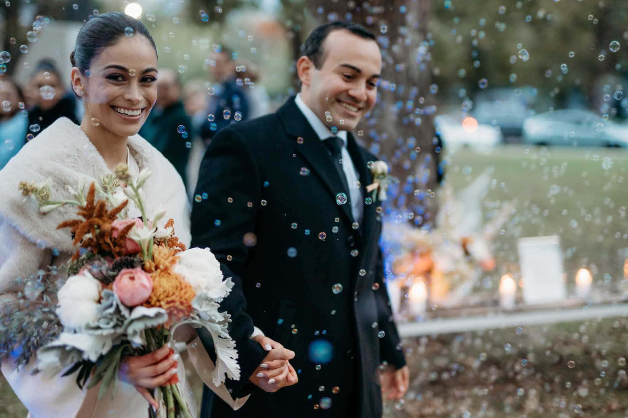Bride and groom celebrating a snowy winter wedding in Denver
