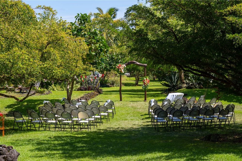 Lush outdoor garden wedding ceremony venue setup by Florida wedding planners