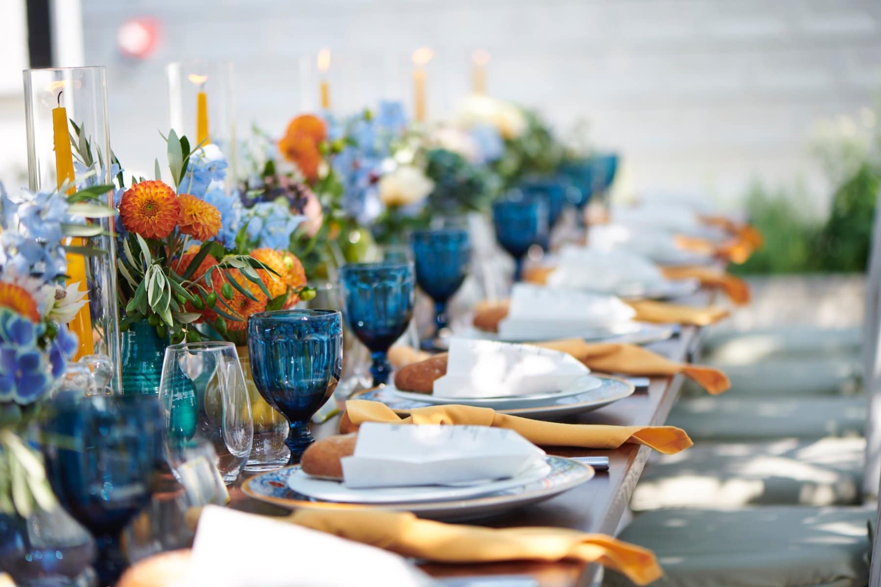 Waterfront outdoor wedding reception table setting designed by Florida wedding planners