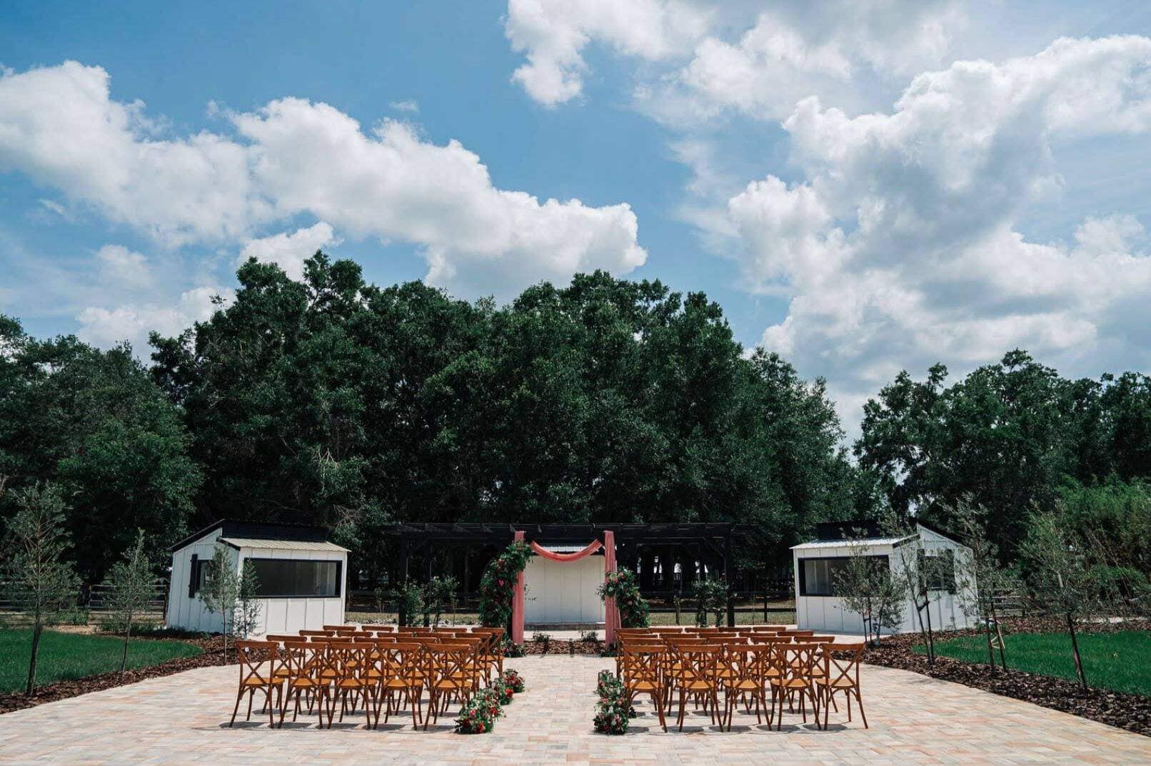 Rustic outdoor ceremony setup with wooden chairs in Jacksonville forest venue