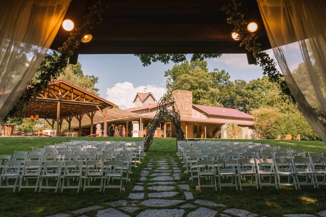 Rustic outdoor wedding venue setup with pavilion in Minnesota landscape