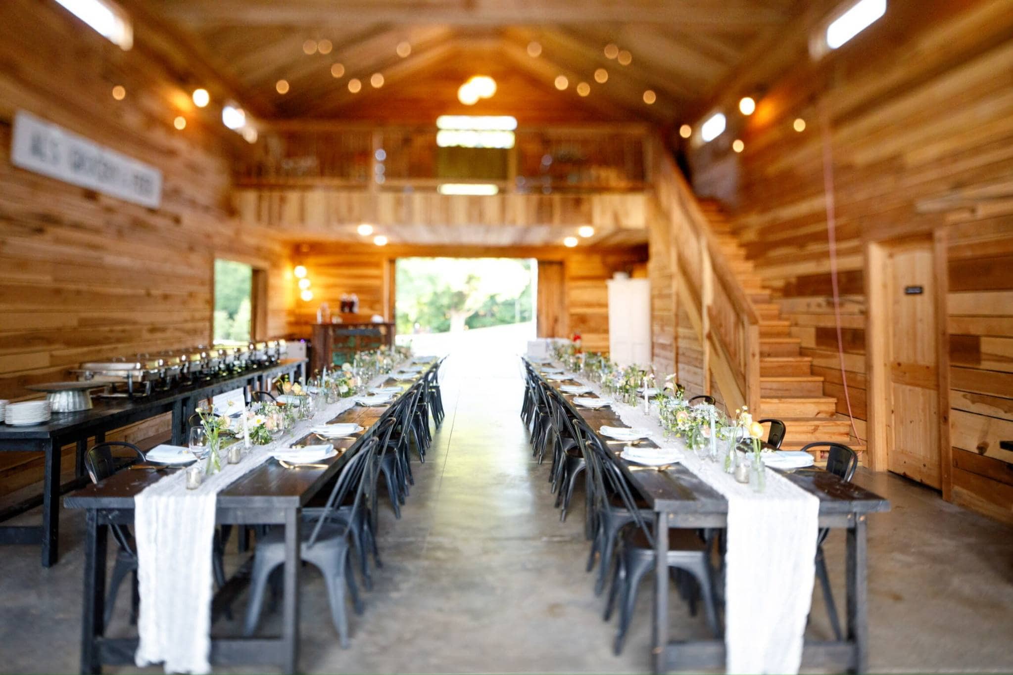 Rustic barn interior event space with long dining table for Minnesota weddings