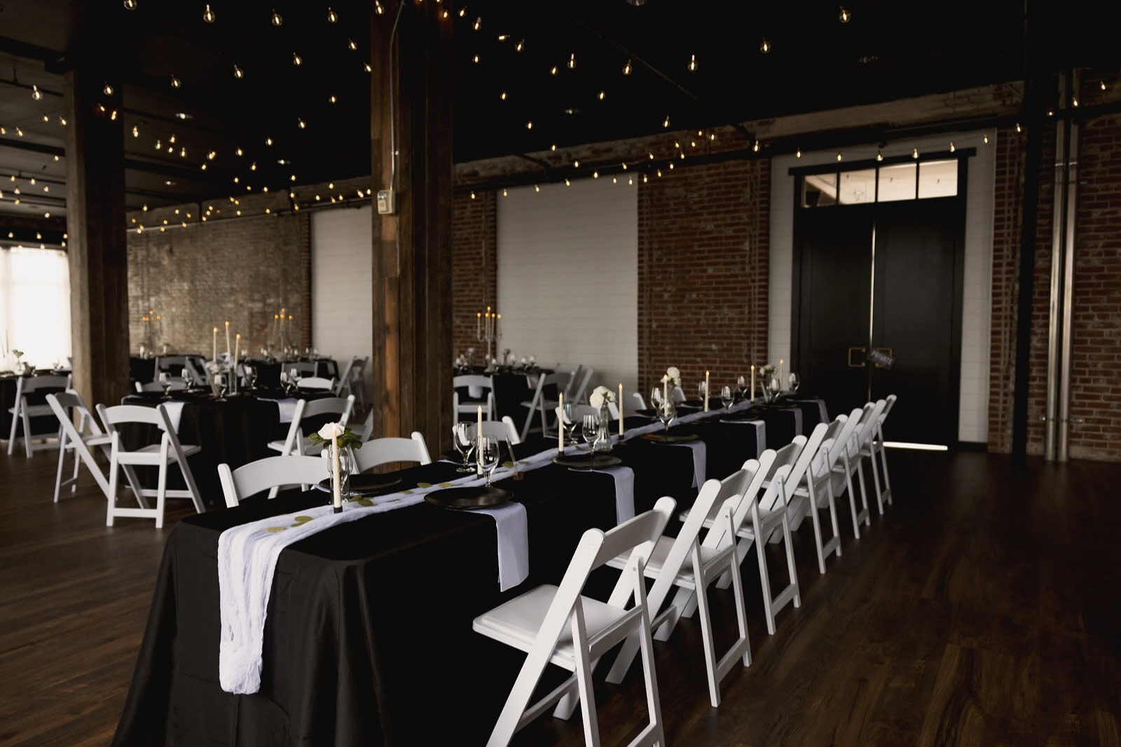 Elegant St. Louis wedding reception venue with exposed brick and lights