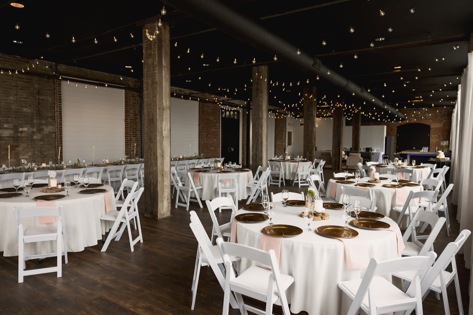 Dimly lit St. Louis wedding reception hall with romantic string lights