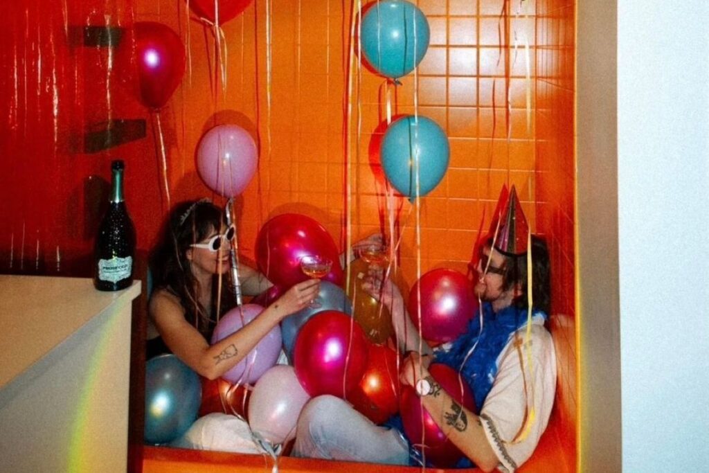 couple with birthday balloons in a bathtub