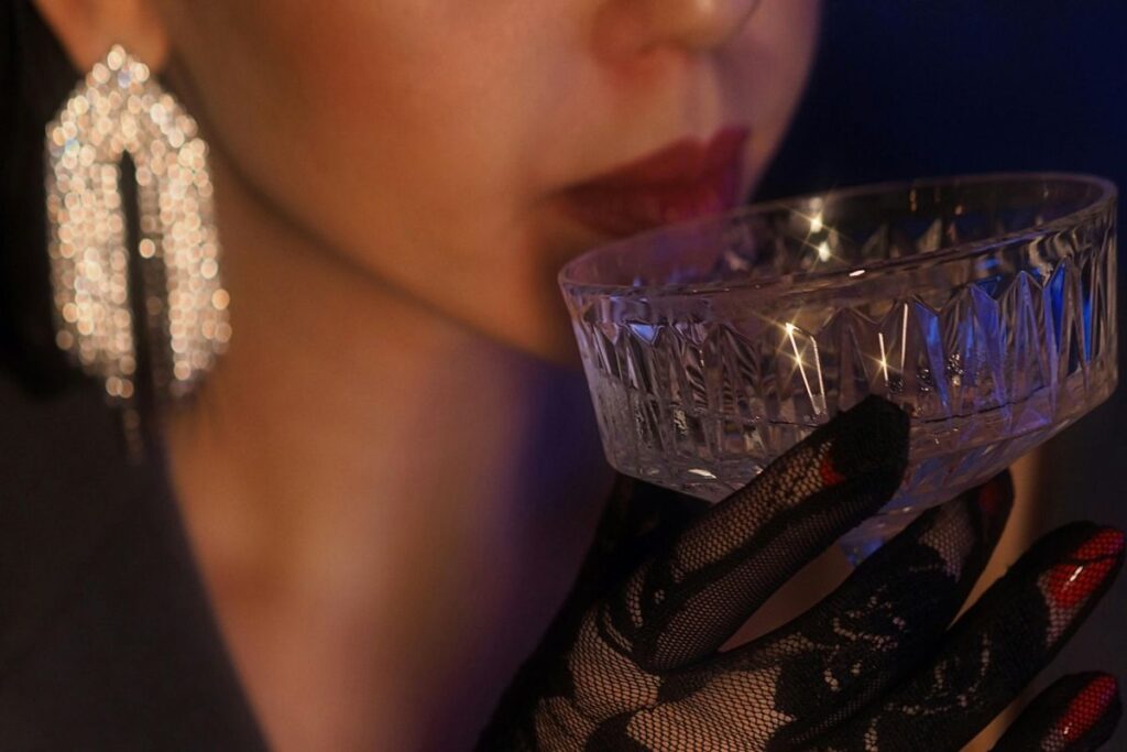 a woman sipping a cocktail close up