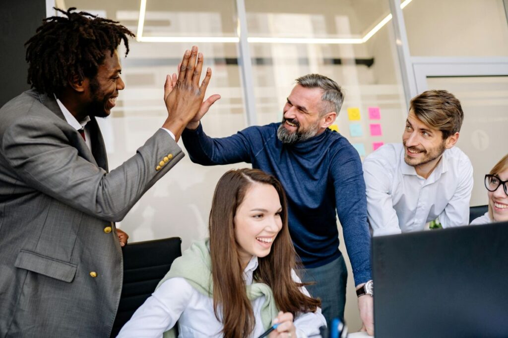 colleagues giving high five at the office