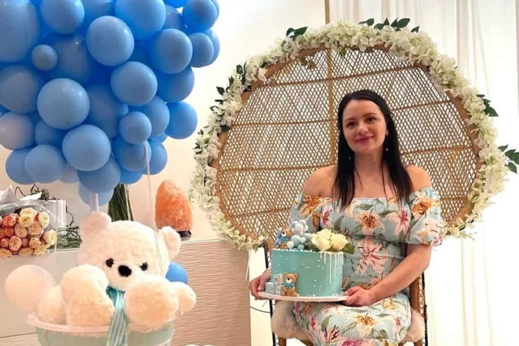 a mom-to-be sitting at her baby shower