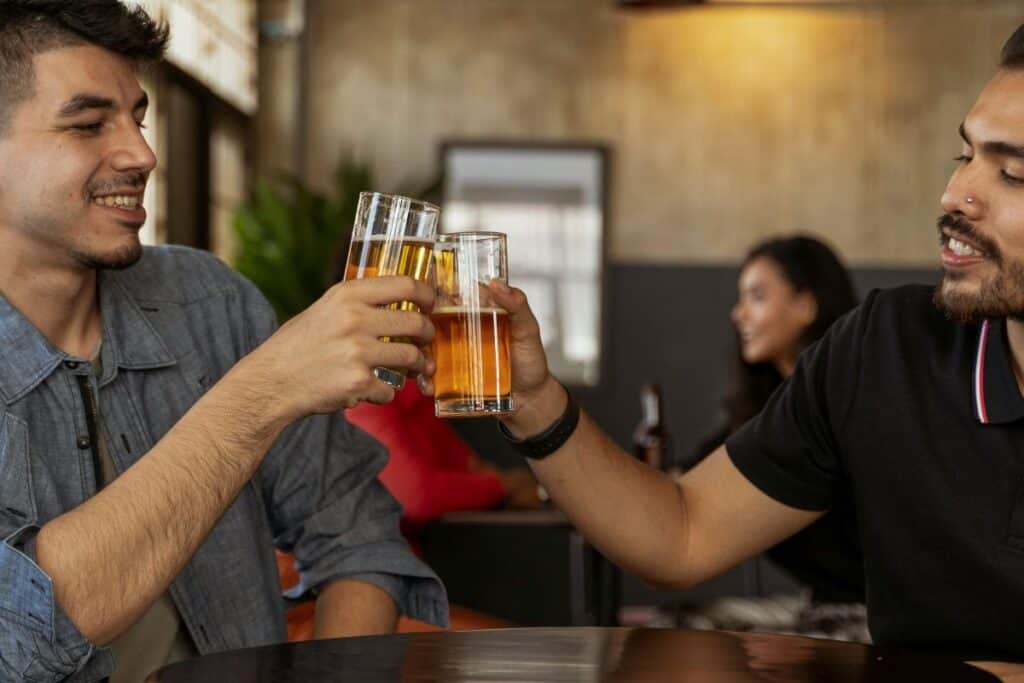 two men toasting at a bar