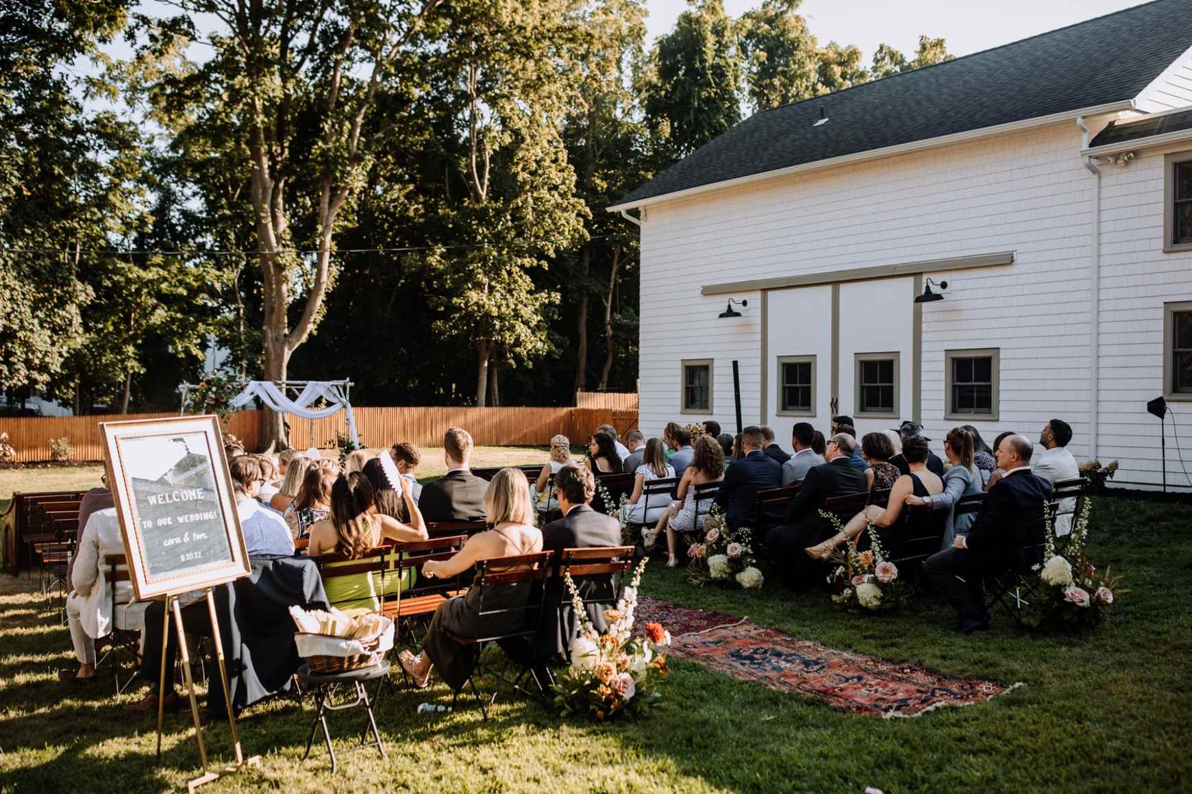 Outdoor backyard wedding ceremony setup with wooden benches in Louisville