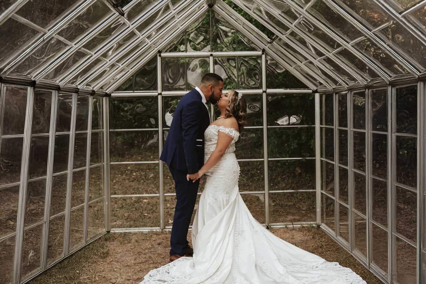 Bride and groom embracing in a Portland greenhouse wedding venue